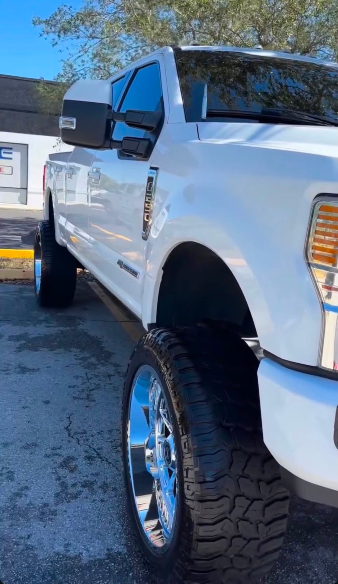 Lifted white Ford Super Duty freshly detailed
