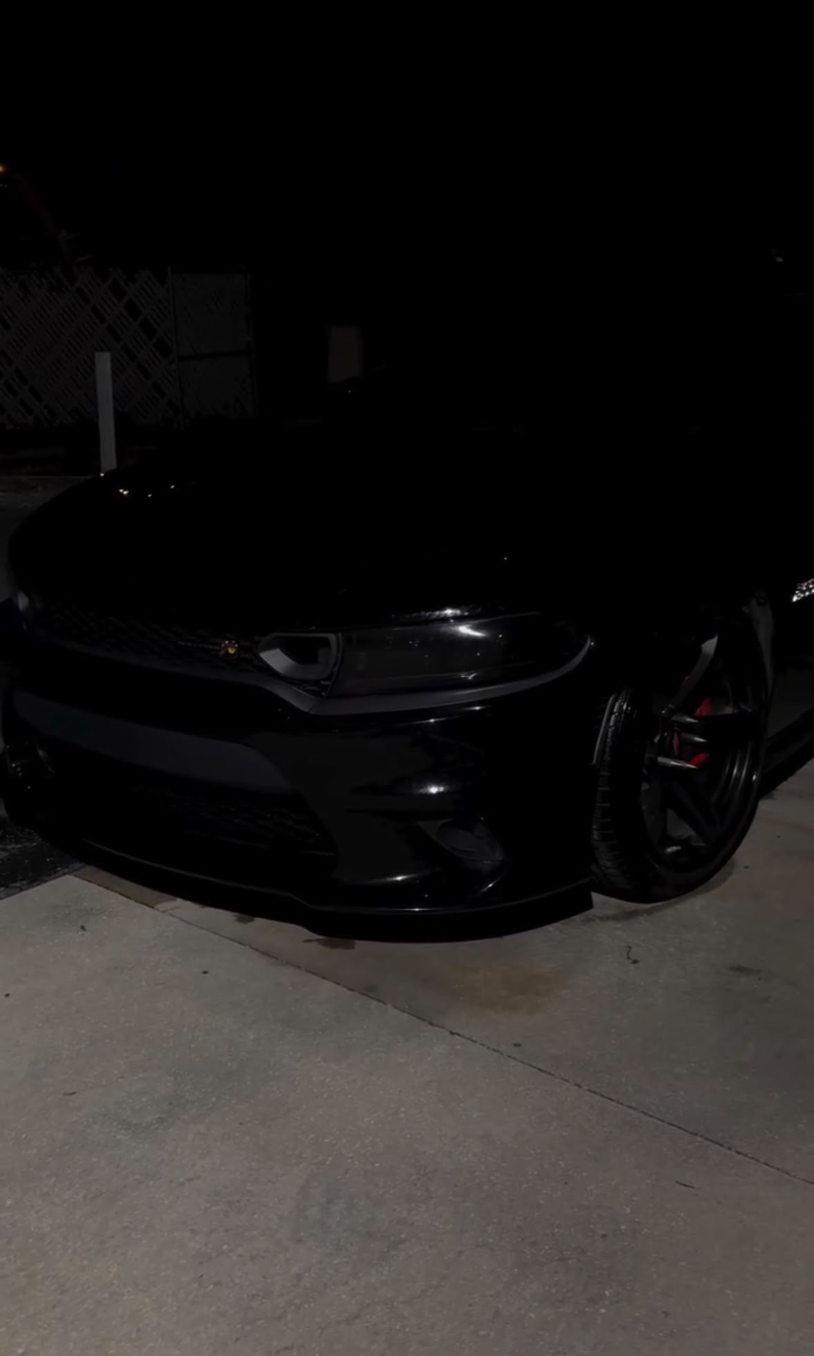 Blacked-out Dodge Charger detailed at night