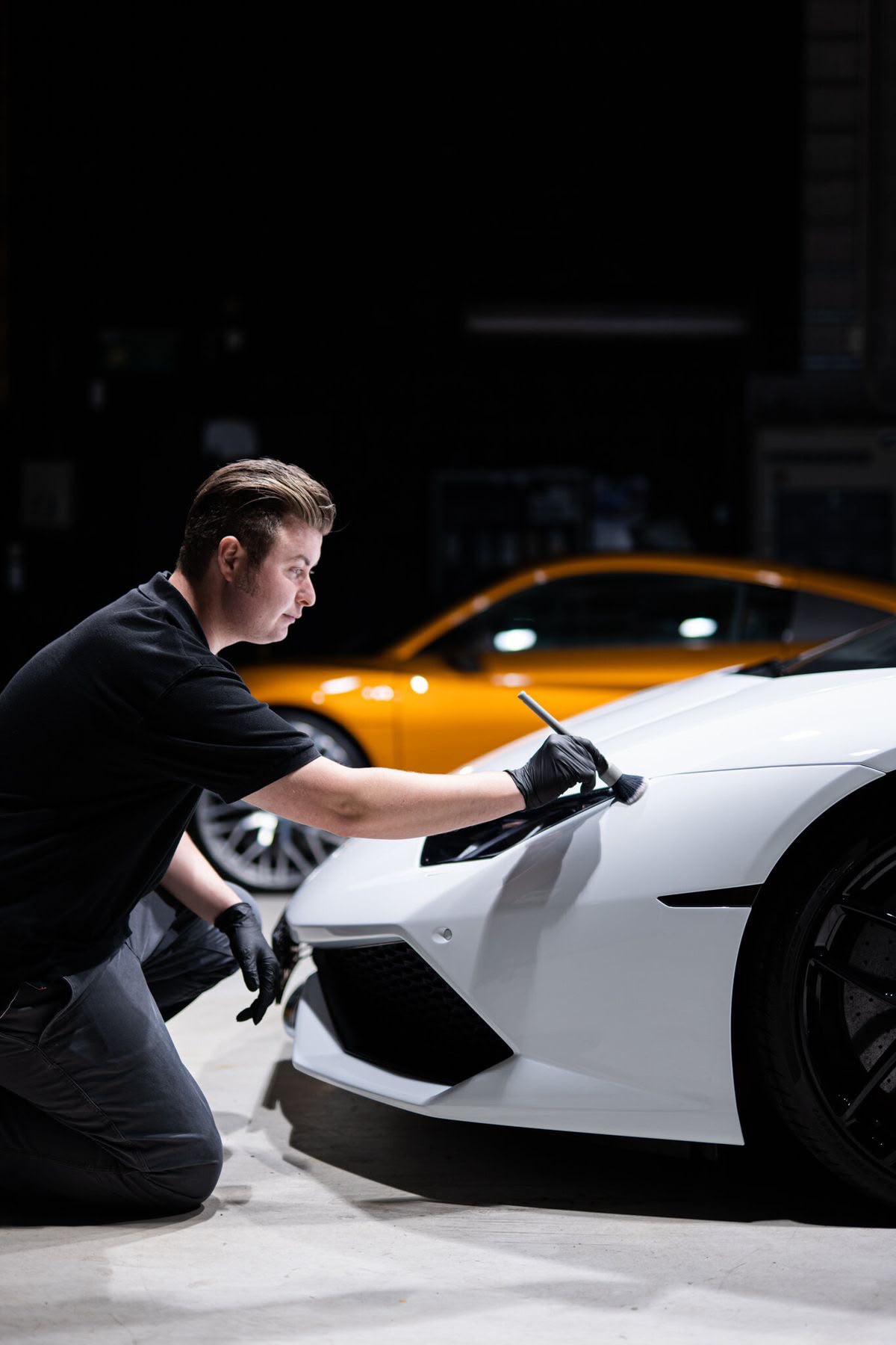 A1 detailer focused on hand-polishing a glossy car